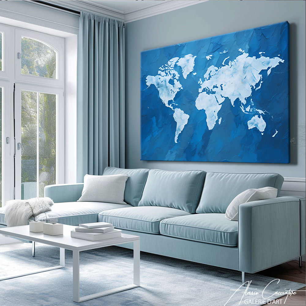 Tableau carte du monde bleu au-dessus d’un canapé bleu ciel dans un salon clair et lumineux
